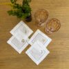 Posavasos blancos calados con bordado beige