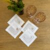 Posavasos blancos calados con bordado beige