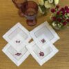 Posavasos blancos calados con bordado guinda